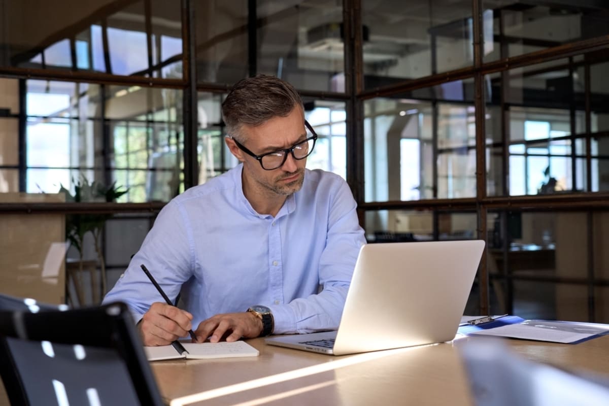 A man at his laptop conducting market research