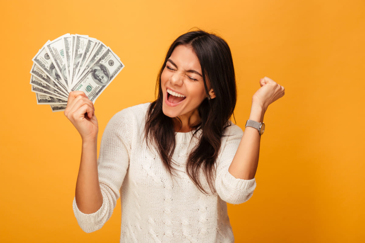 Happy woman with money in her hand - buy my house fast concept