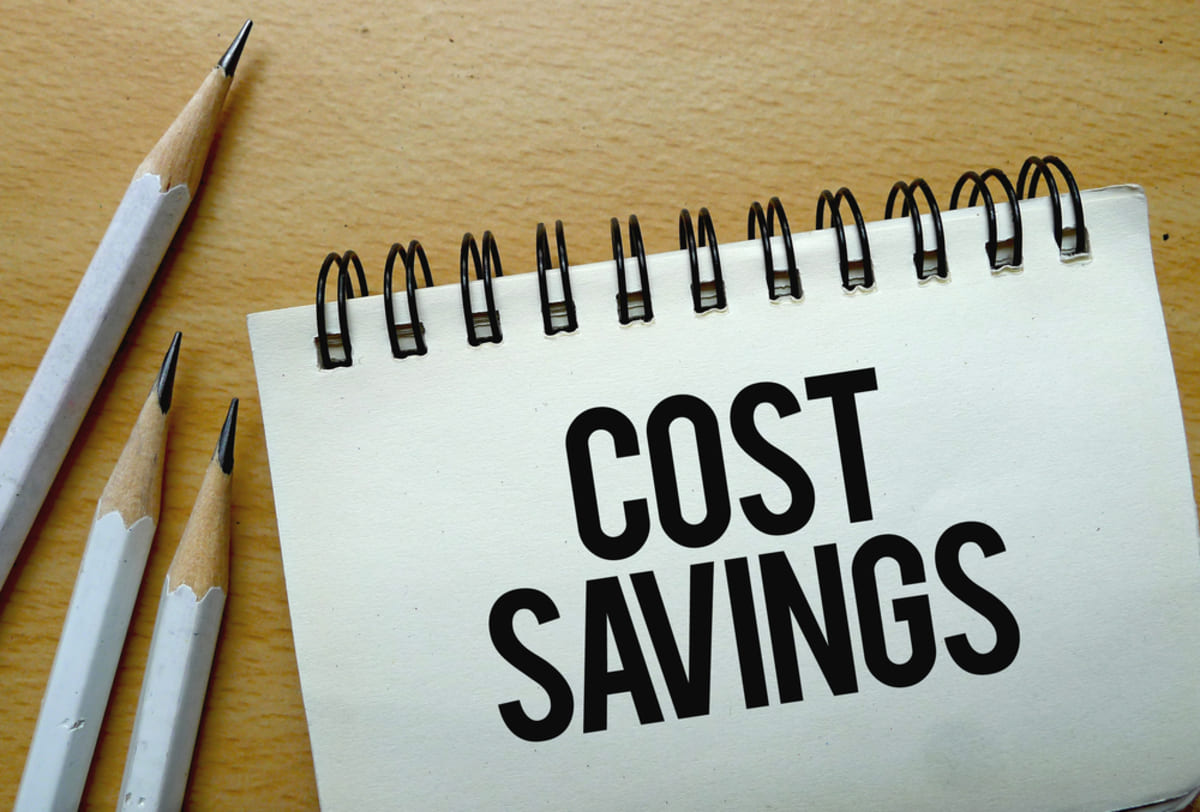 The word cost savings on a notepad