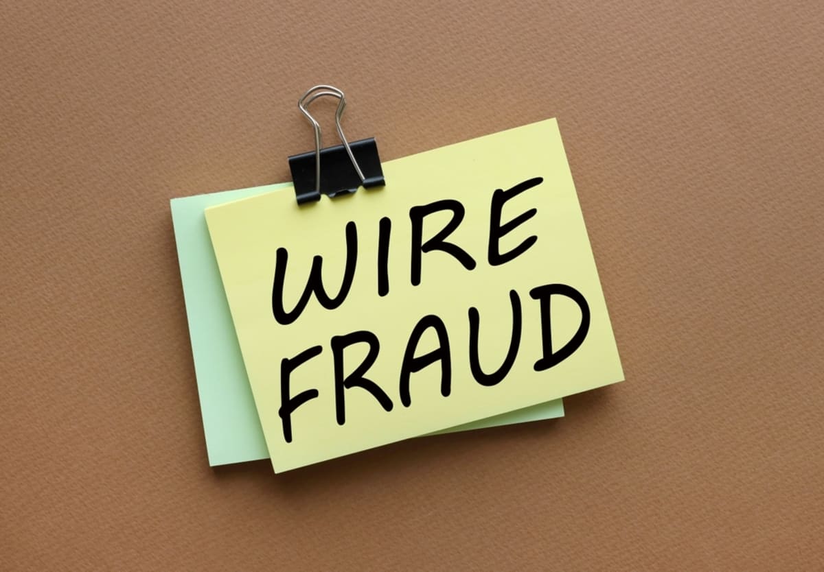 Wire Fraud on a notecard, beware of real estate scams concept