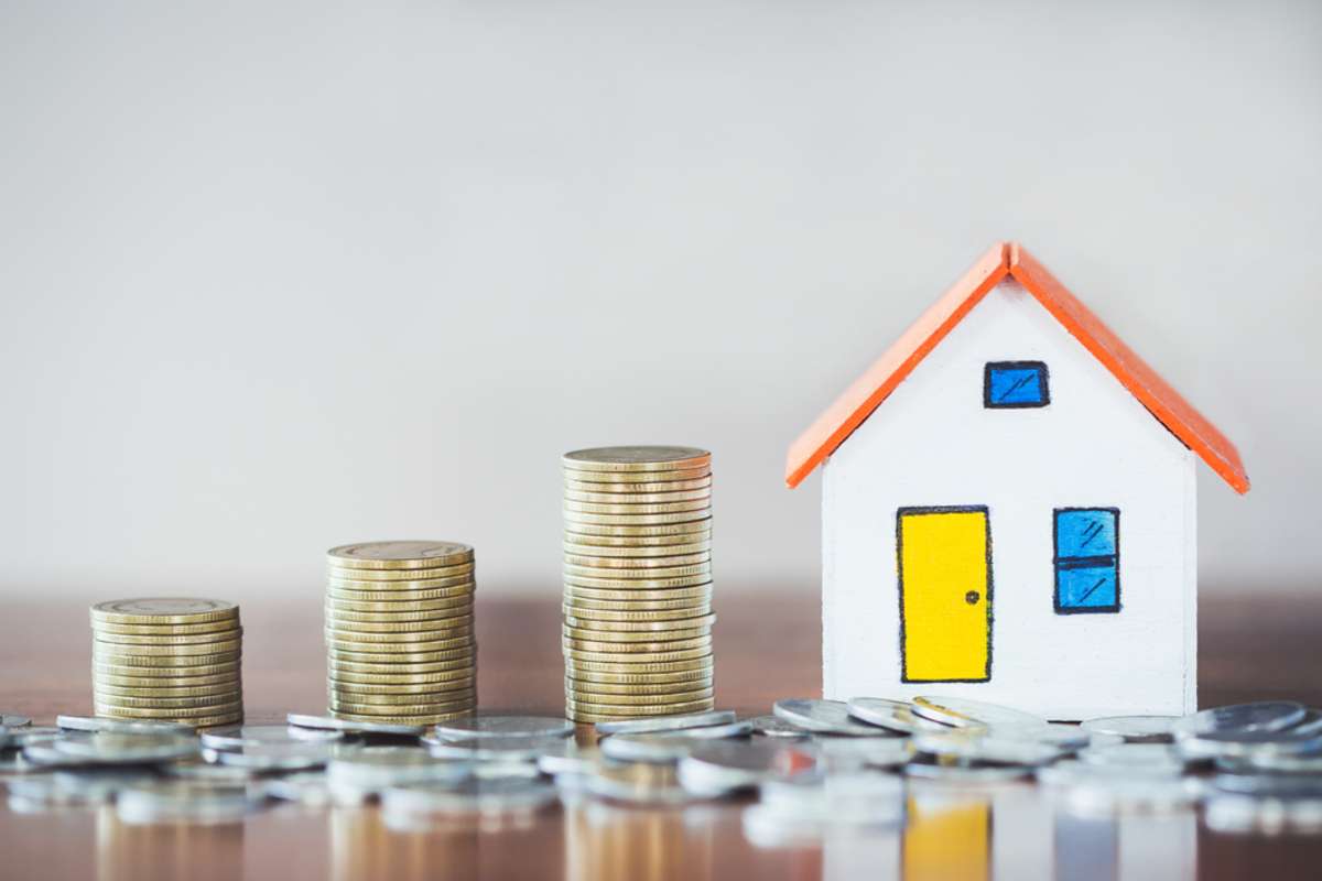 House model and coin money on table for finance and banking concept